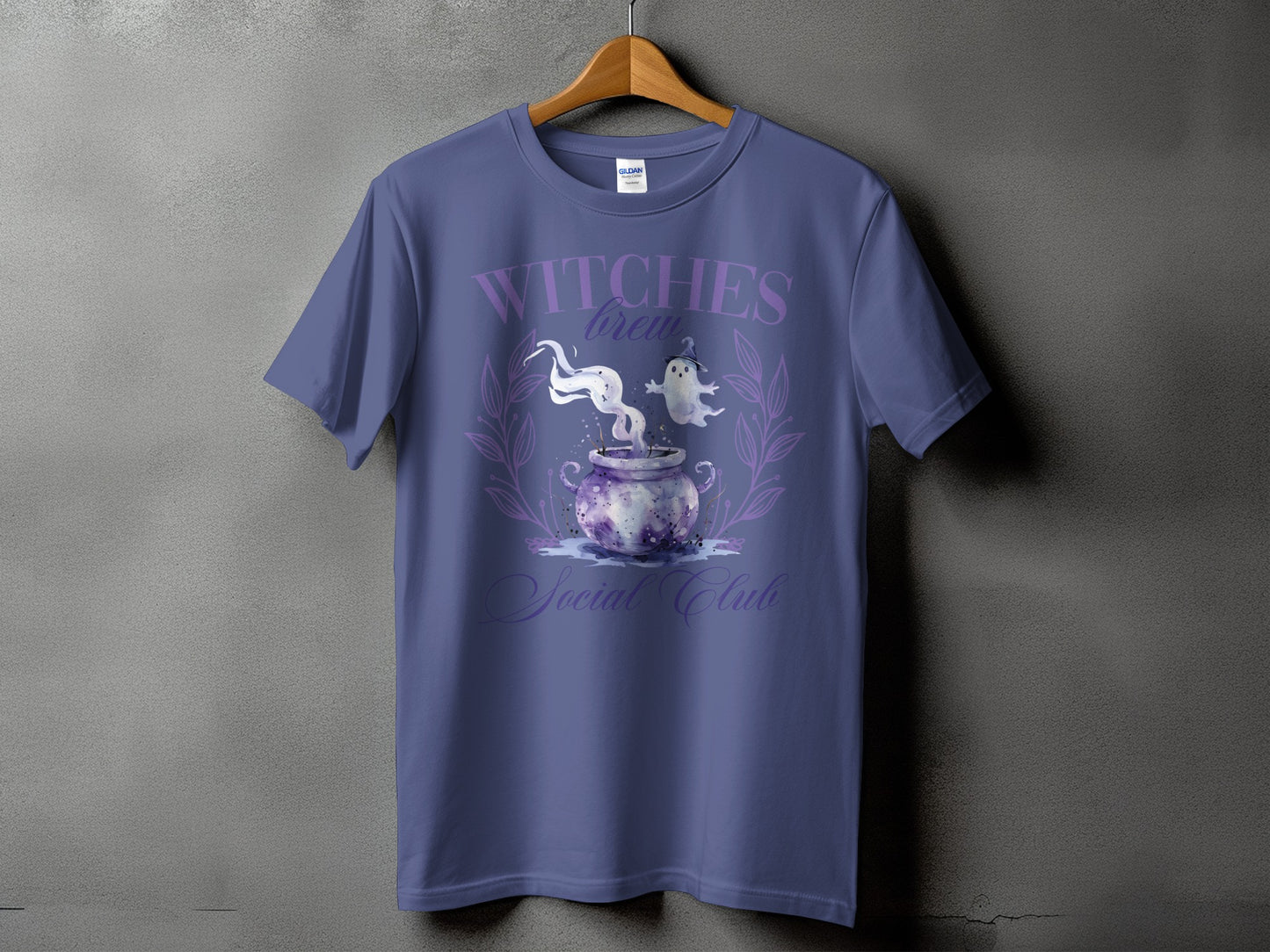 Purple t-shirt with "Witches Brew Social Club" text and cauldron graphic.