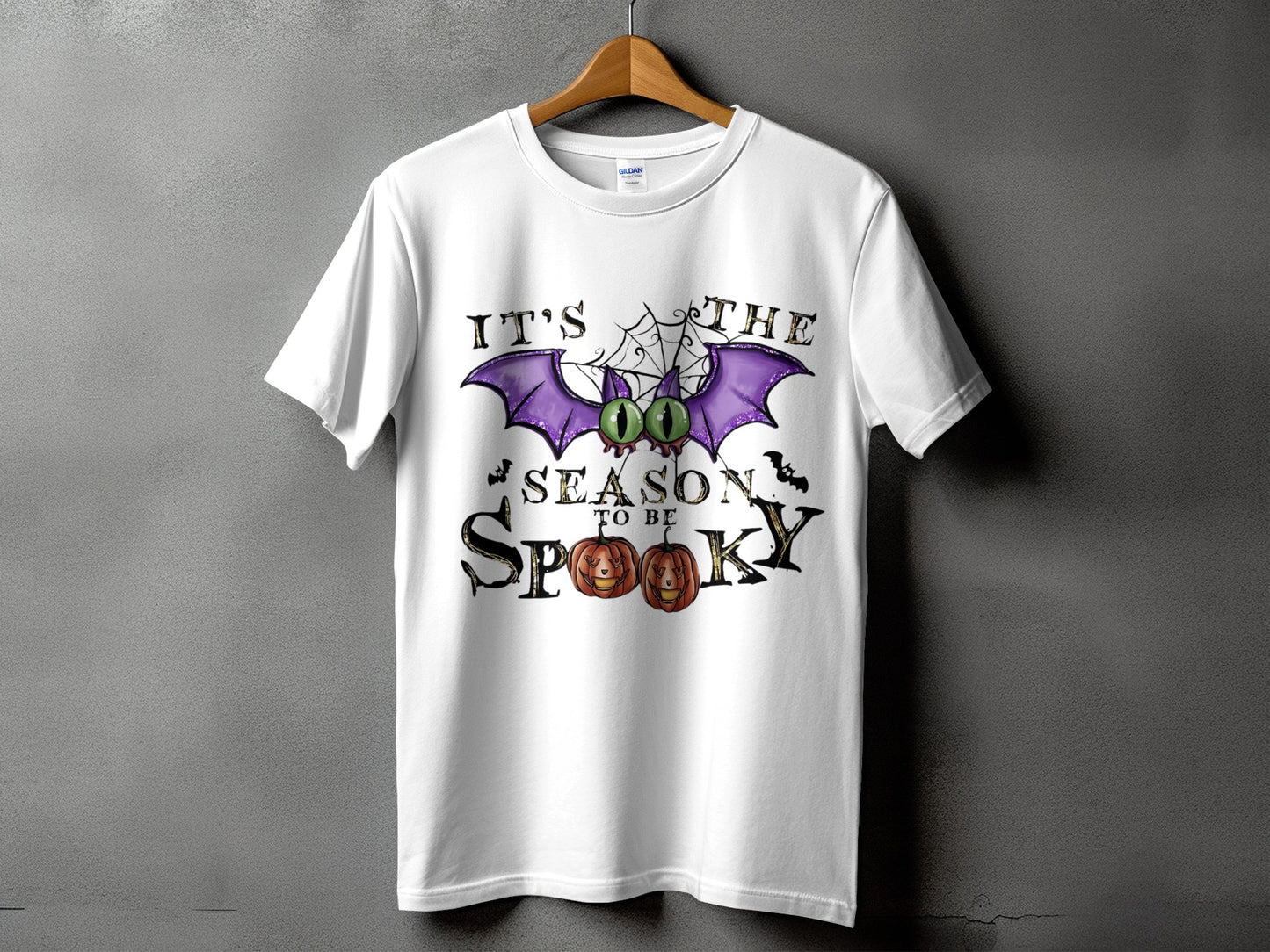 White t-shirt with "IT'S THE SEASON TO BE SPOOKY" Halloween graphic.