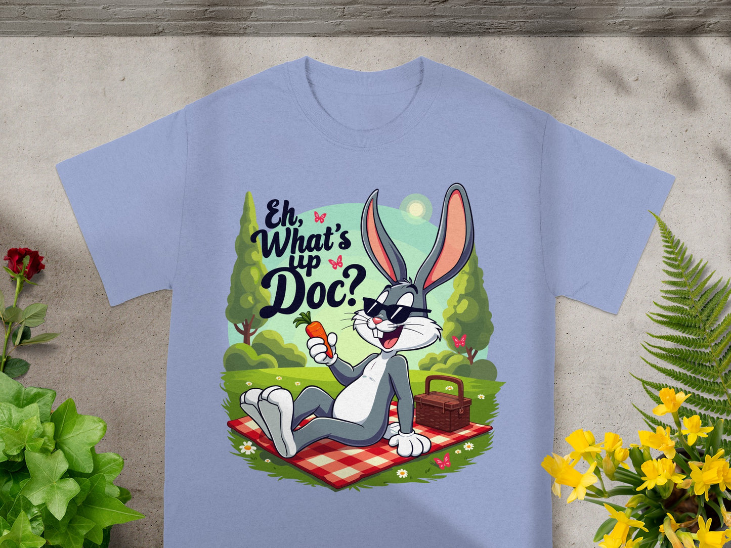Bugs Bunny in sunglasses sits on a picnic blanket with a carrot.