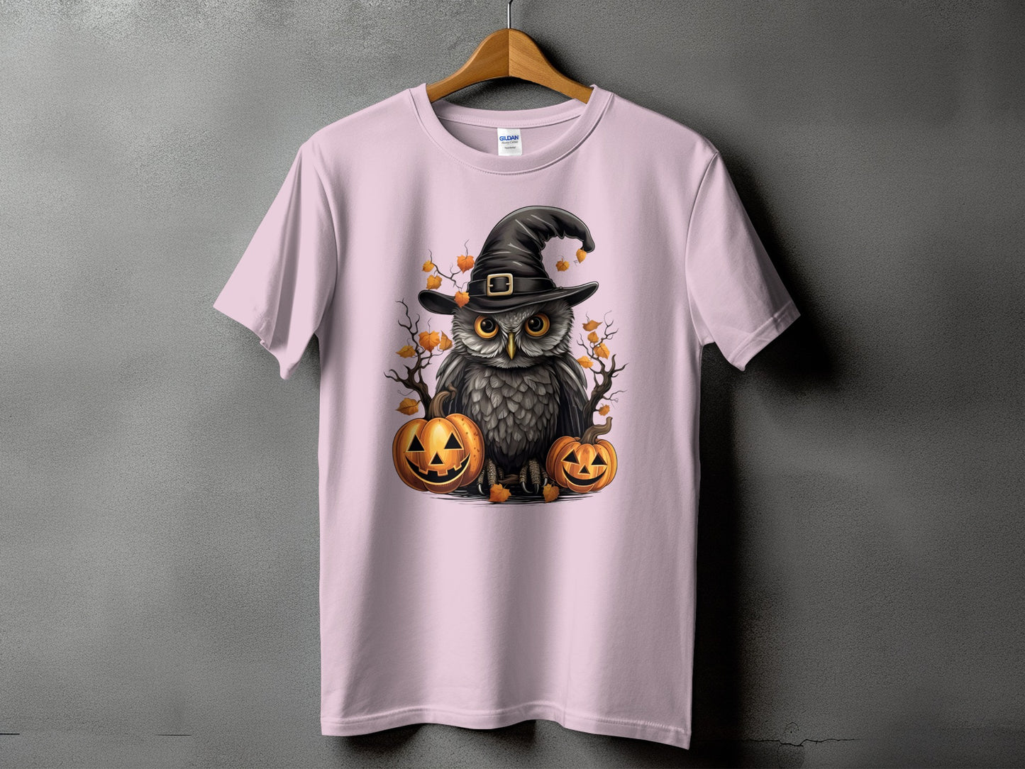 Pink t-shirt with a Halloween owl wearing a witch hat and pumpkins design.