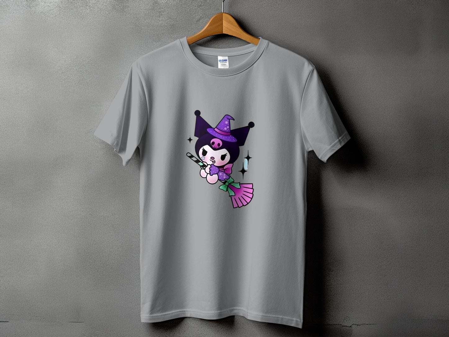 Grey t-shirt with a graphic of Kuromi in a witch hat holding a broomstick.