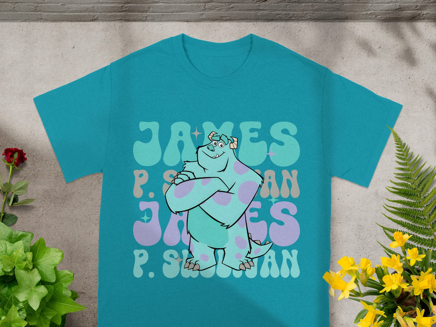 Teal t-shirt with "James P. Sullivan" text in a playful font.