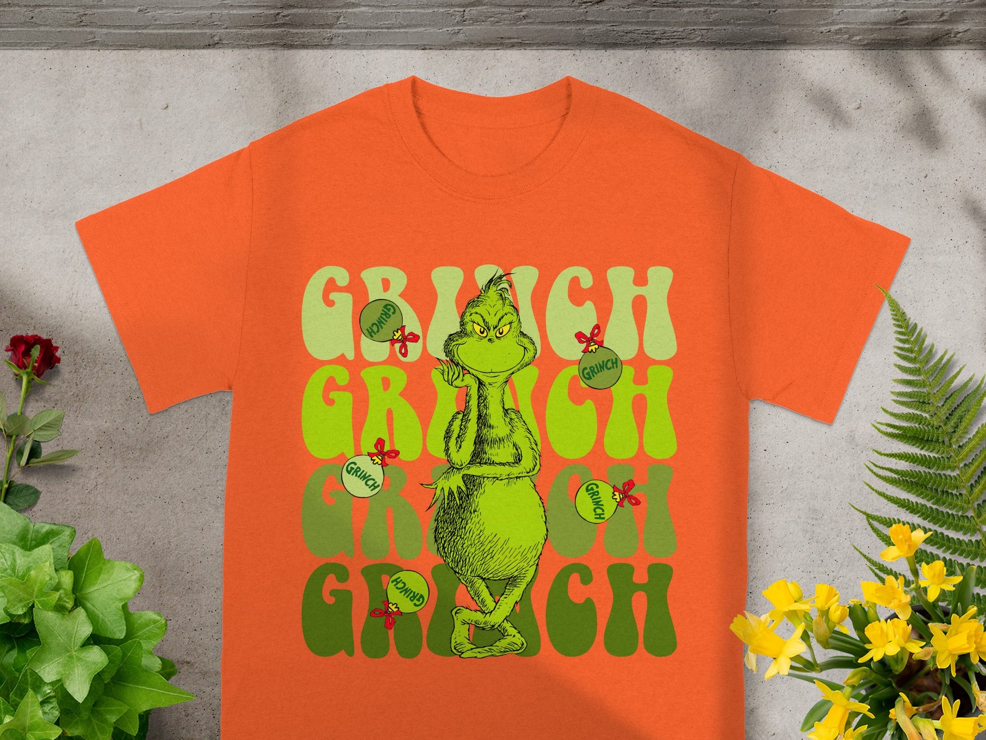 Orange t-shirt with "Grinch" text and the character.