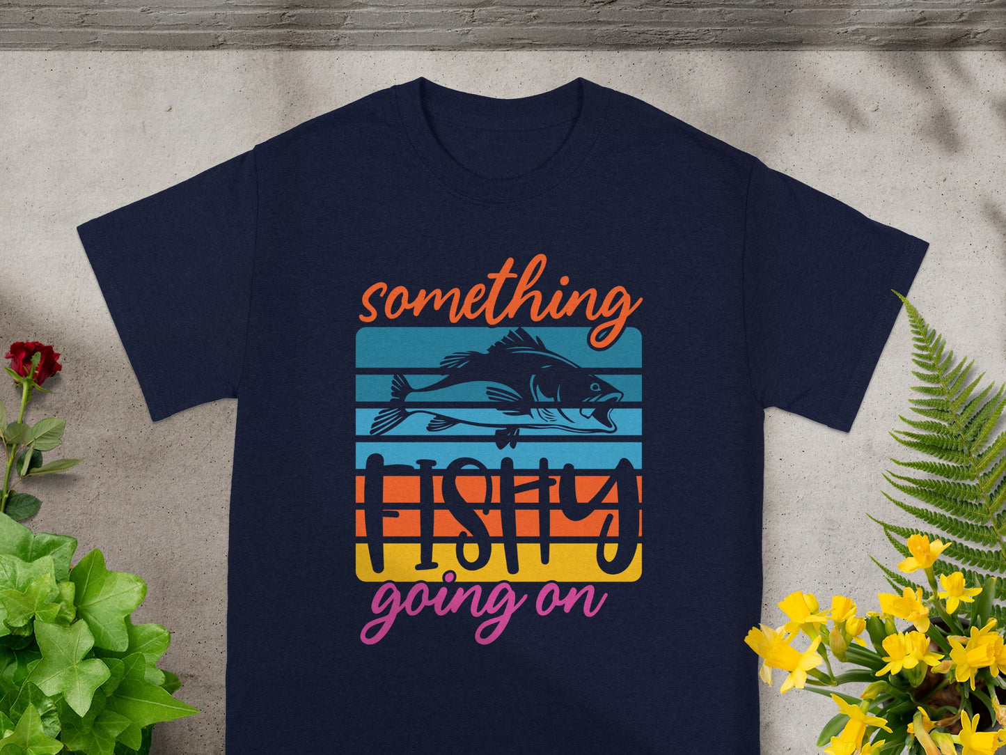 Navy t-shirt with "something FISHY going on" text and a fish graphic.