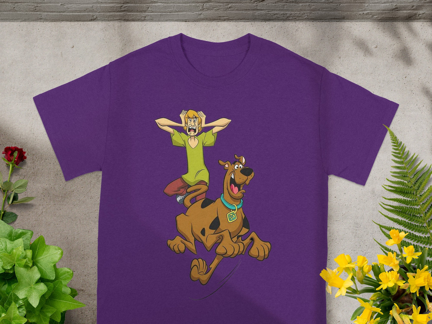 Scooby-Doo and Shaggy running in terror on a purple t-shirt.