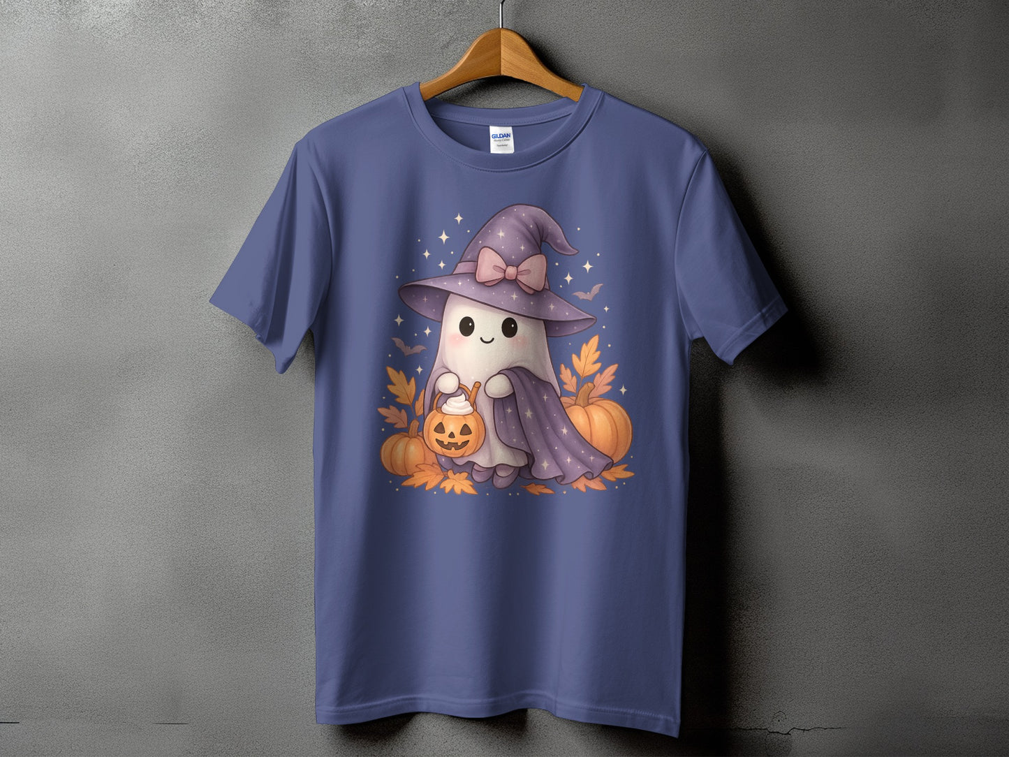 T-shirt with a cute ghost wearing a witch hat holding a pumpkin basket.