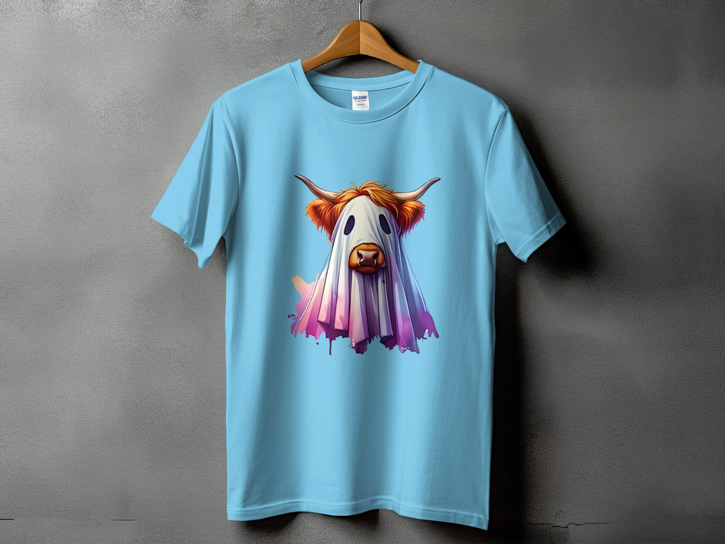 Light blue t-shirt with a Highland cow dressed as a ghost graphic.