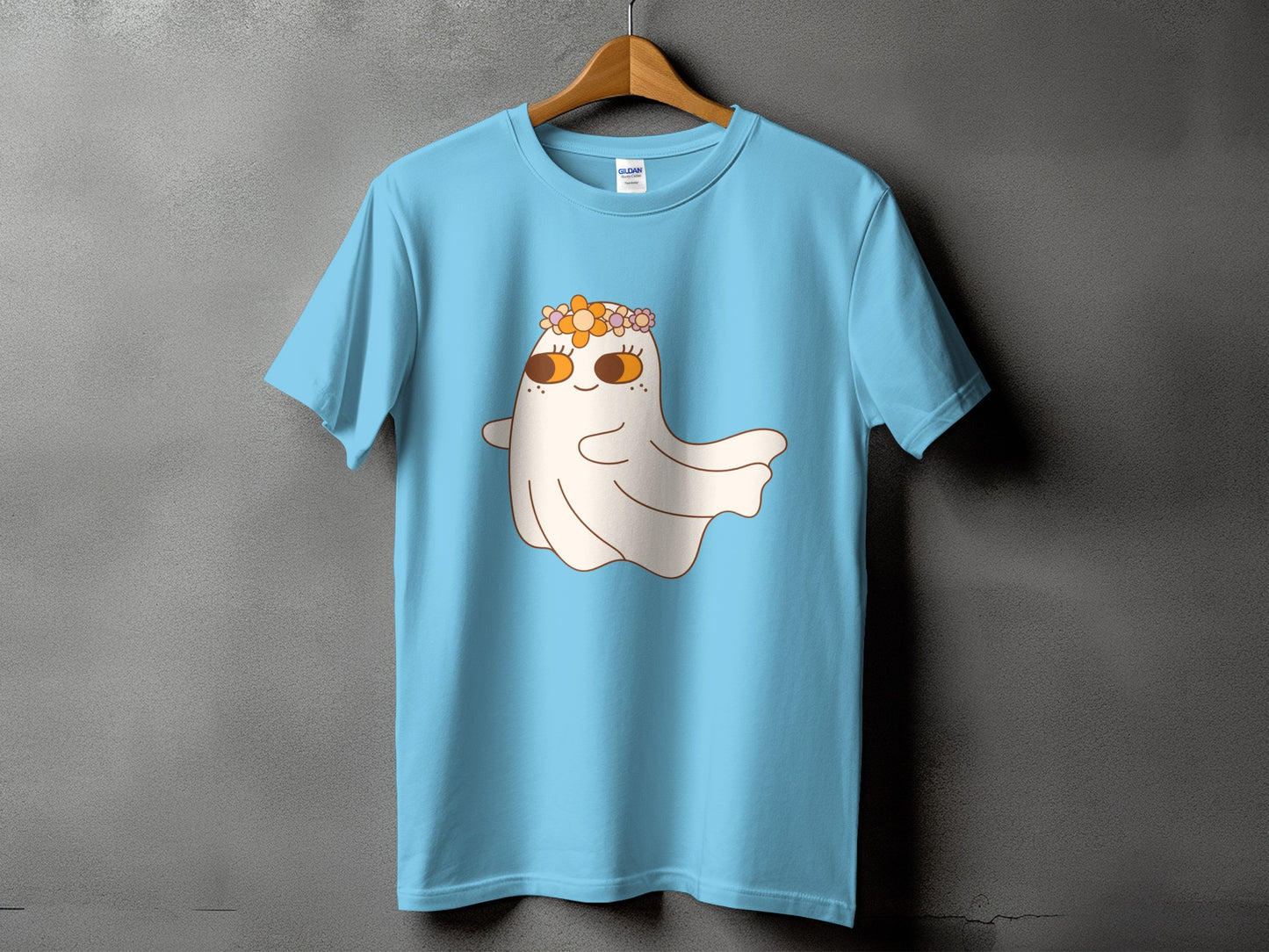 Light blue t-shirt with a cartoon ghost wearing a flower crown on the front.
