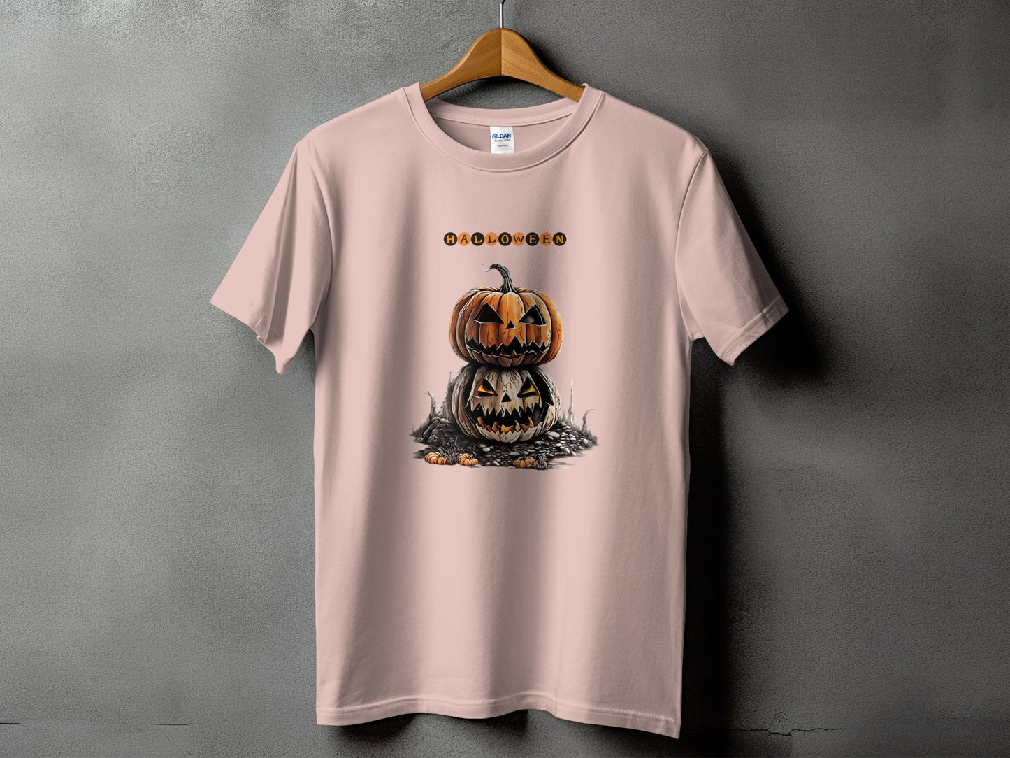 Pink t-shirt with stacked jack-o'-lanterns and "Halloween" text.