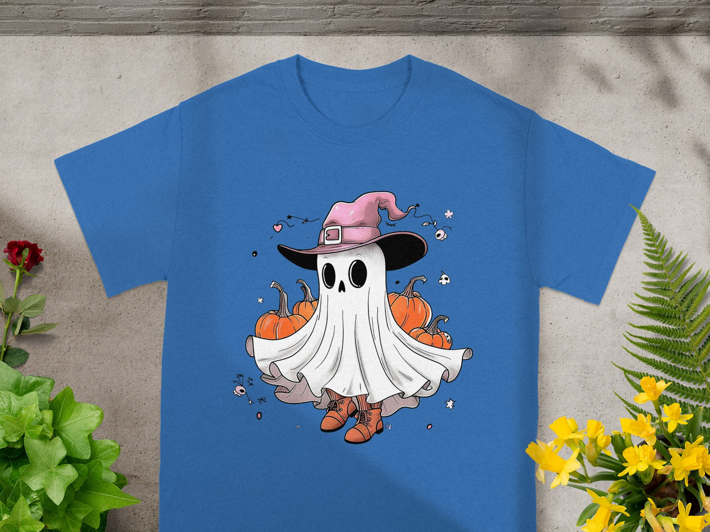 Blue t-shirt with a cartoon ghost wearing a pink witch hat and boots with pumpkins.