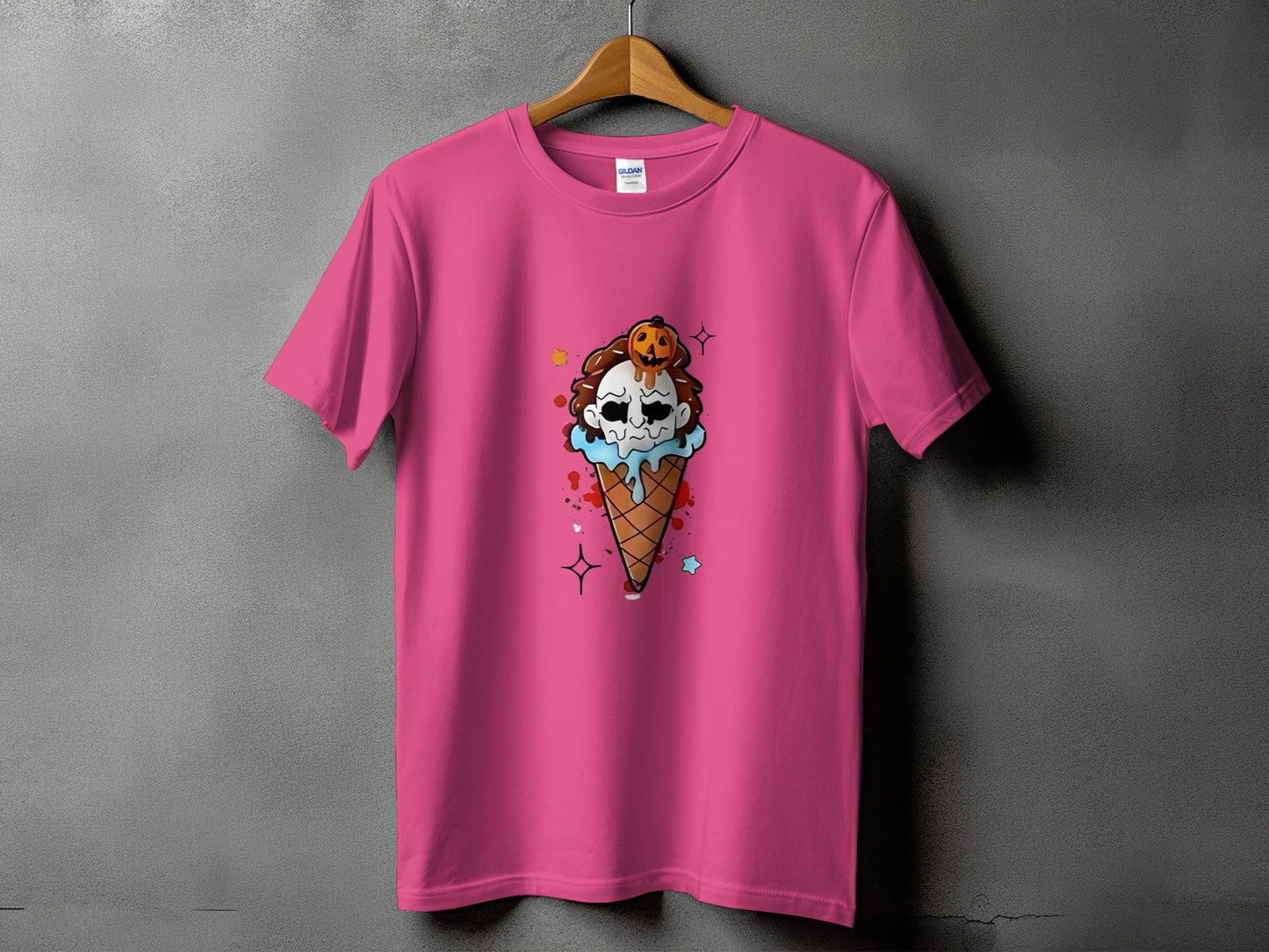 Pink t-shirt with a Halloween ice cream cone graphic featuring a skull and pumpkin.