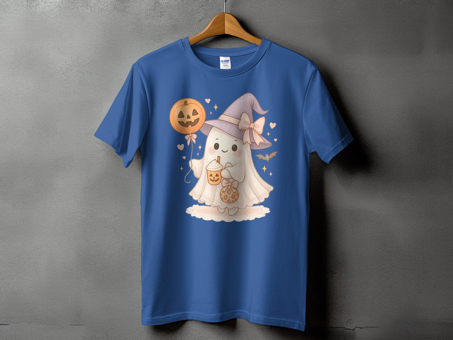 Blue t-shirt with a cute ghost wearing a witch hat holding a pumpkin balloon and a drink.