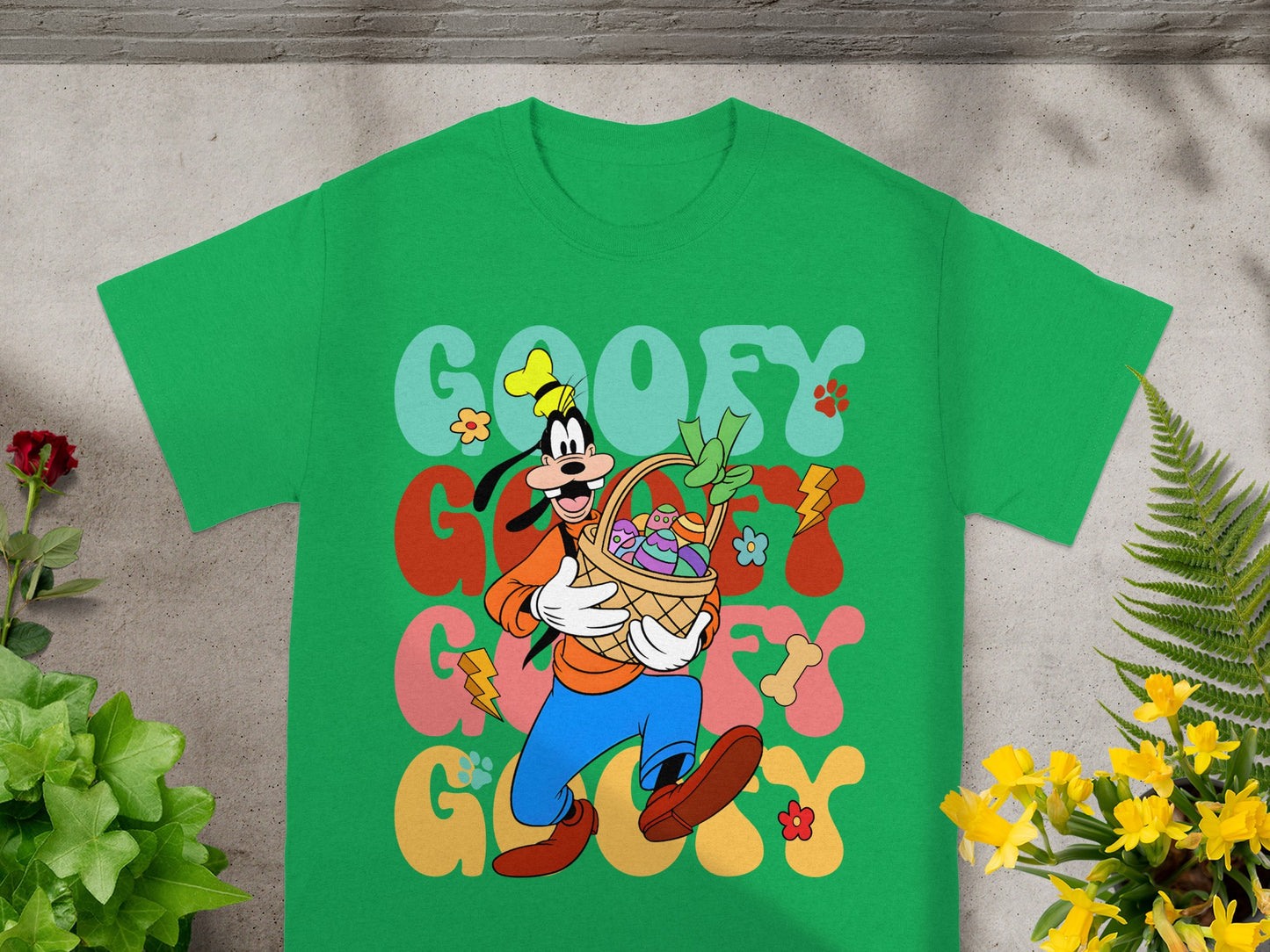 Green t-shirt with Goofy holding an Easter basket and colorful text.