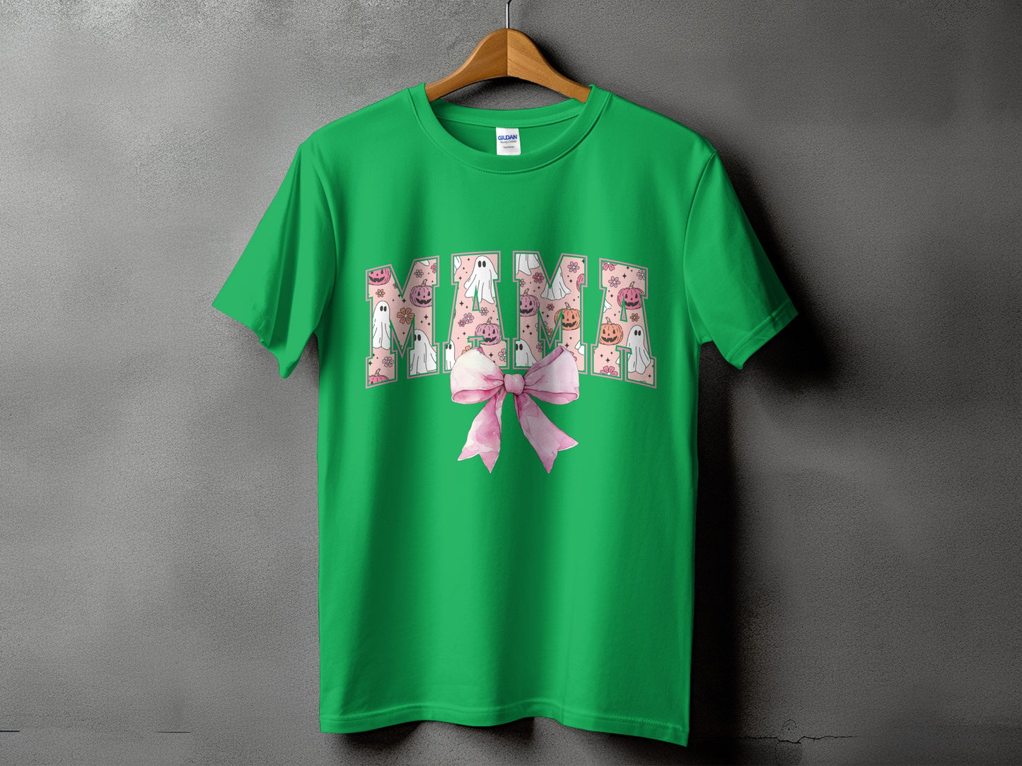Green t-shirt with "Mama" text filled with Halloween ghosts and pumpkins.