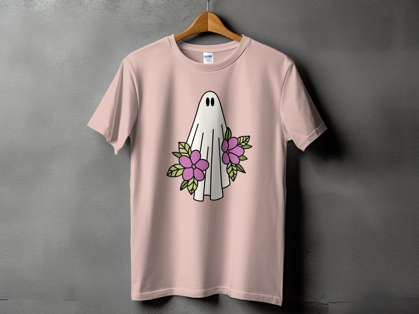 Pink t-shirt with a white ghost and purple flowers graphic.