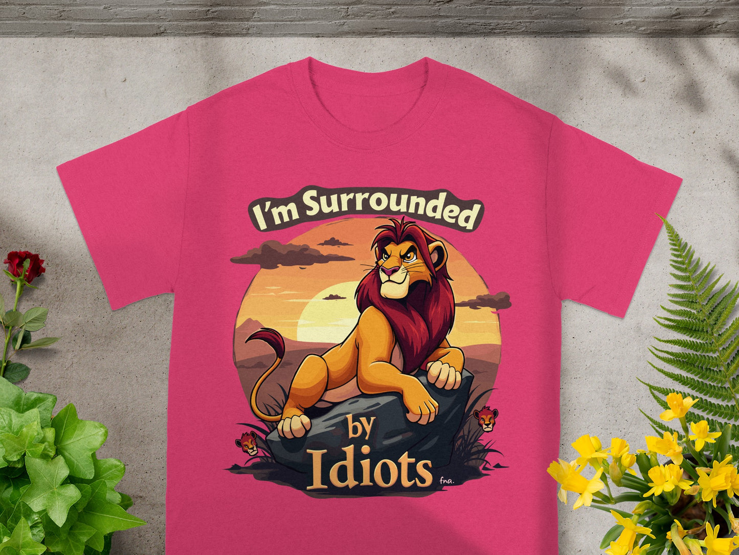 Pink t-shirt with a lion graphic and "I'm Surrounded by Idiots" text.