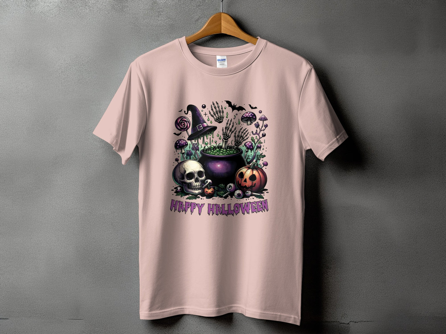 Pink t-shirt with Halloween graphic of skull, pumpkin, cauldron, witch hat, and bats.