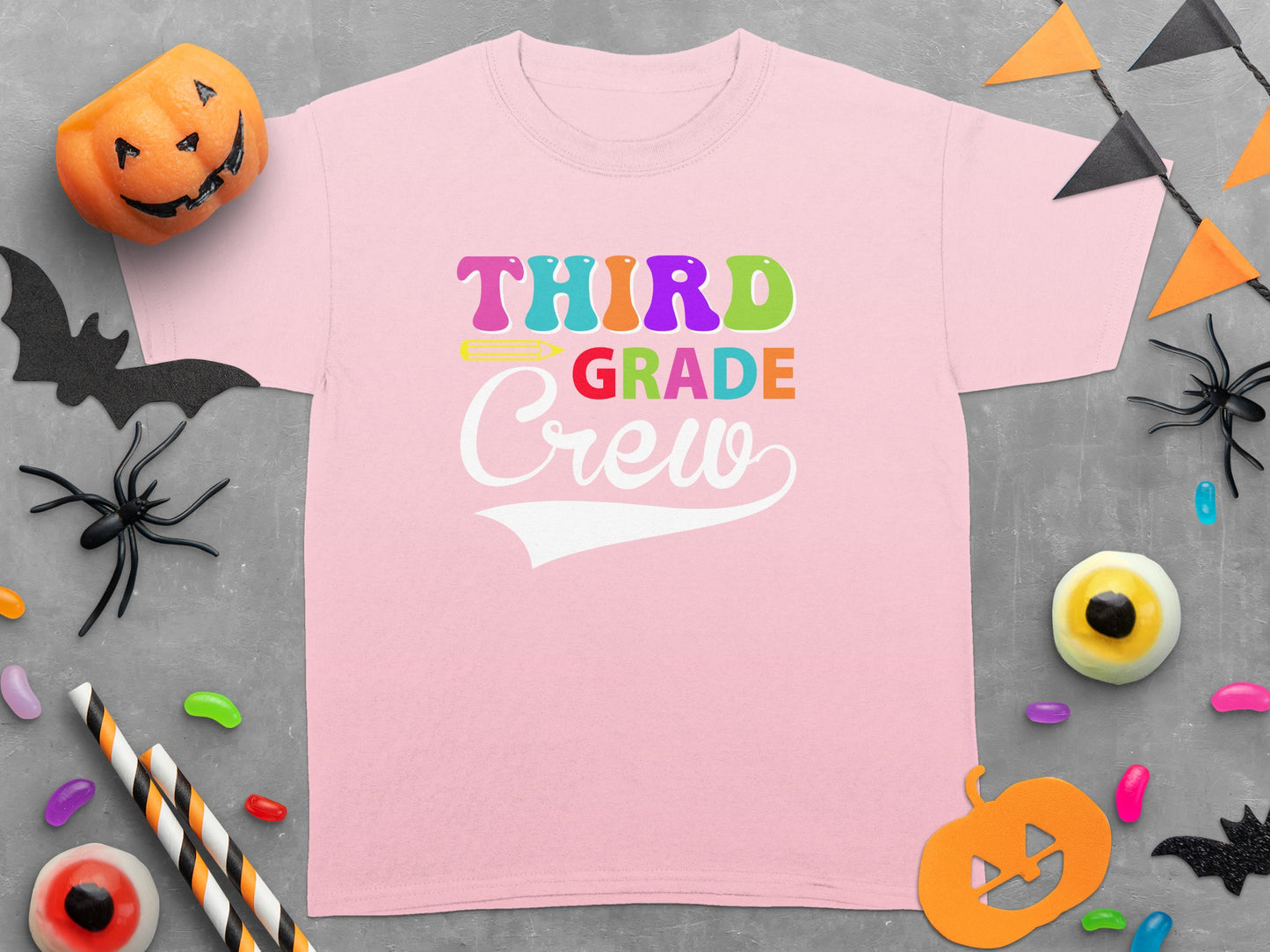 Pink t-shirt with colorful "THIRD GRADE Crew" text and Halloween decorations.