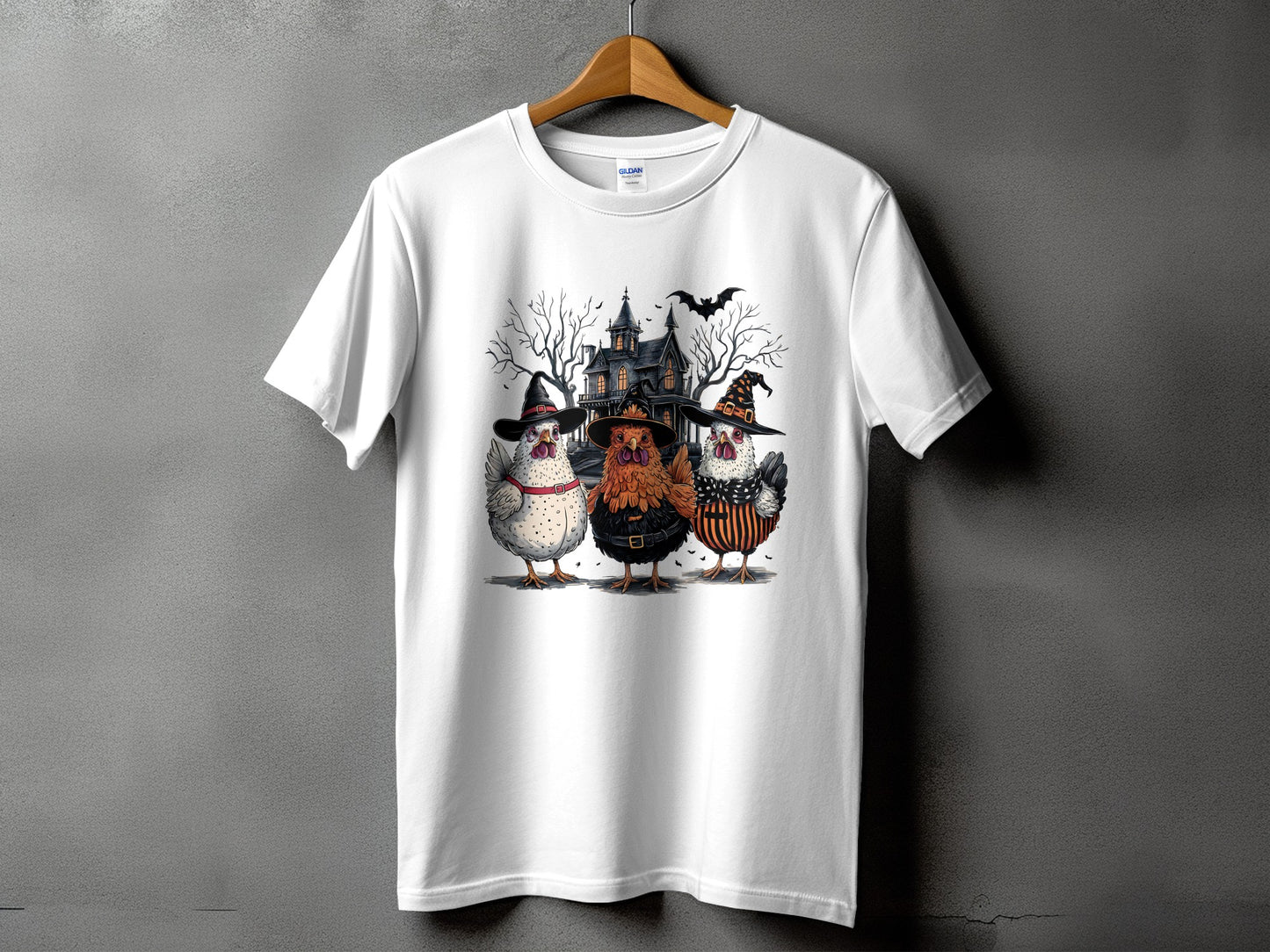 Three chickens in Halloween costumes stand before a haunted house and bare trees.