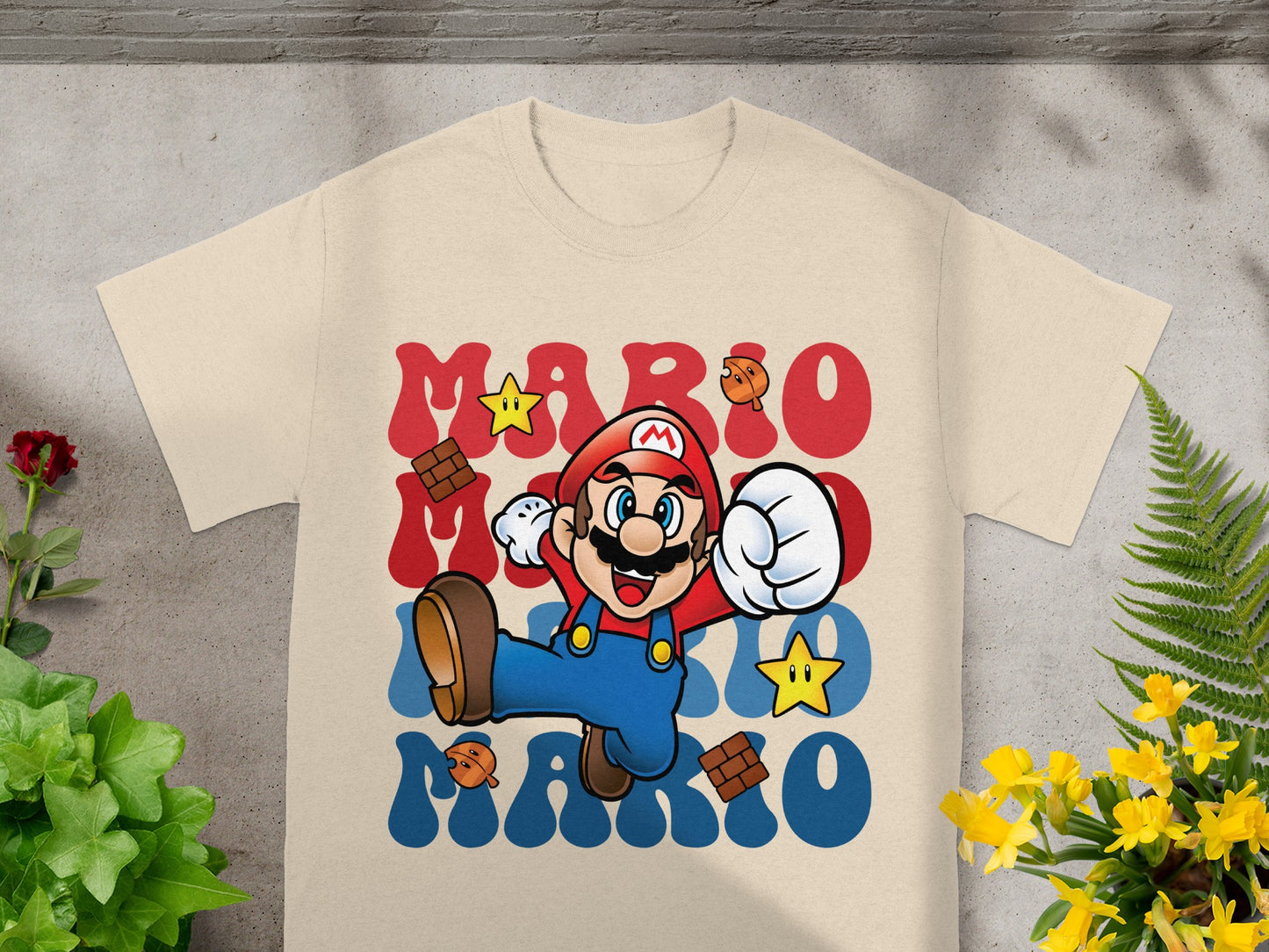 Mario character graphic with "MARIO MARIO" text on a tan t-shirt.