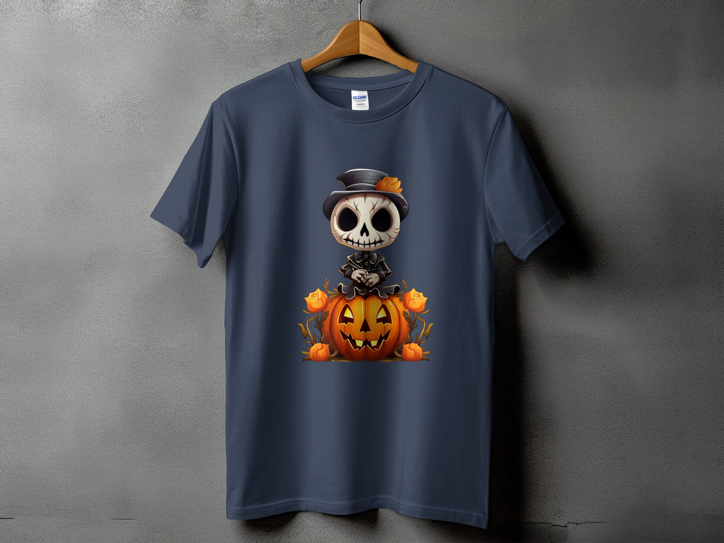 Dark blue t-shirt featuring a cartoon skeleton sitting on a pumpkin with orange roses.