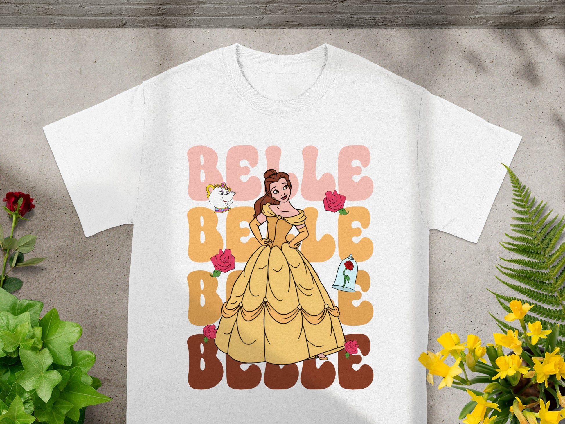 Belle from Beauty and the Beast on a white t-shirt with yellow, pink, and brown text.