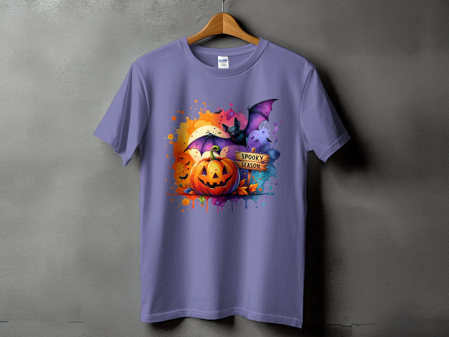 Purple t-shirt with a Halloween graphic featuring a pumpkin, bat, and "Spooky Season" sign.