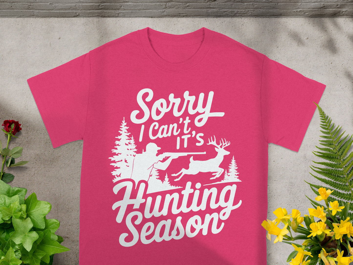 Pink t-shirt with white graphic of hunter, deer, and forest scene with text "Sorry I Can't It's Hunting Season".