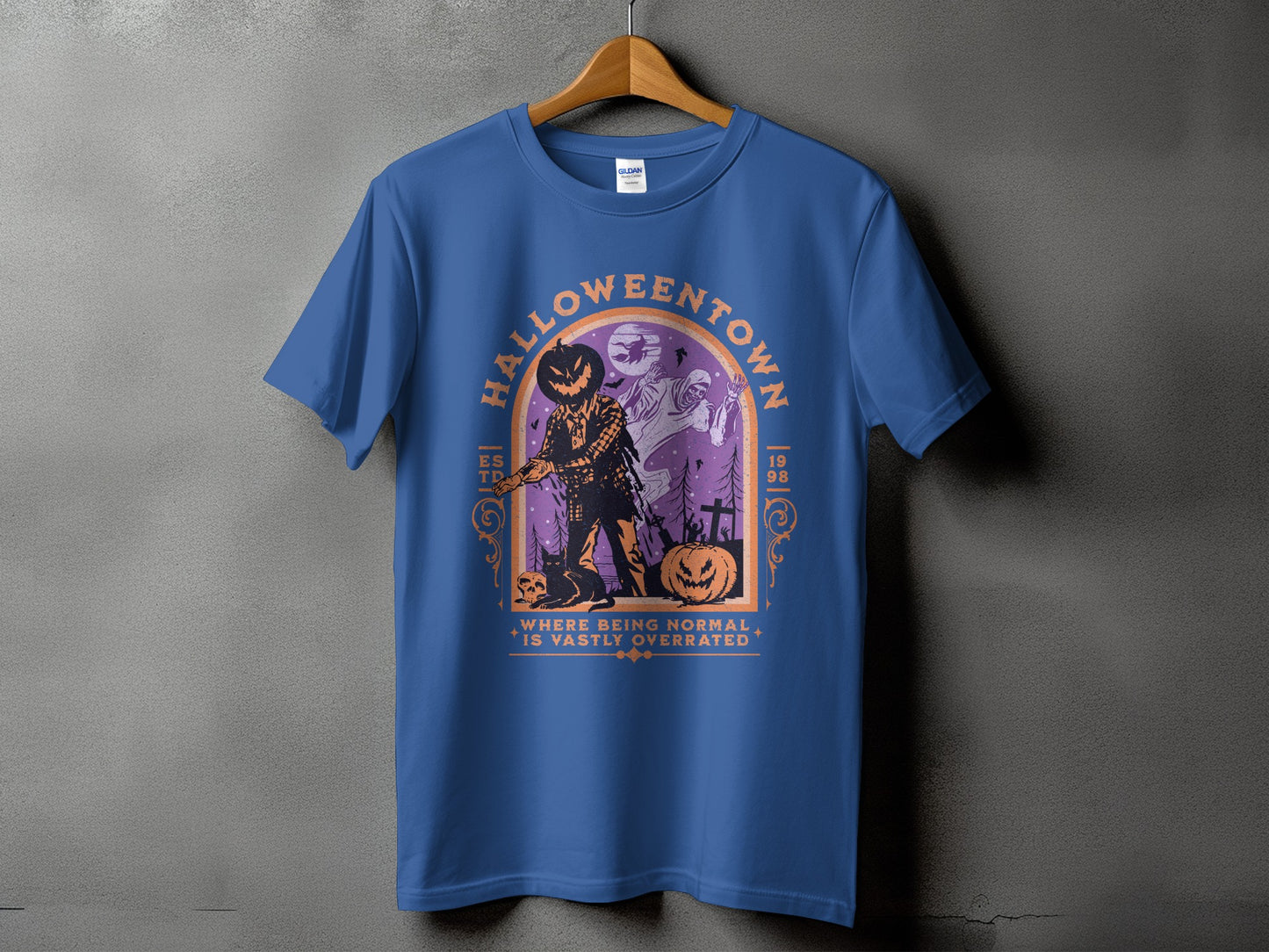 Blue t-shirt with a Halloween design featuring a scarecrow, ghosts, and pumpkins.