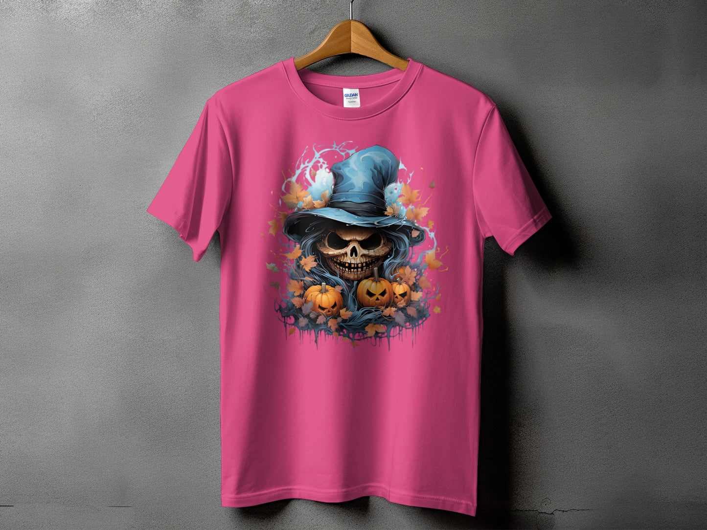 Pink t-shirt with a skull in a wizard hat, pumpkins, and autumn leaves design.
