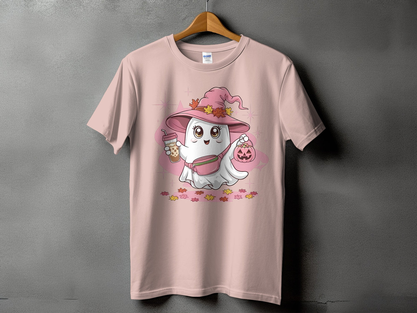Cute ghost wearing witch hat with drink and pumpkin on pink t-shirt.