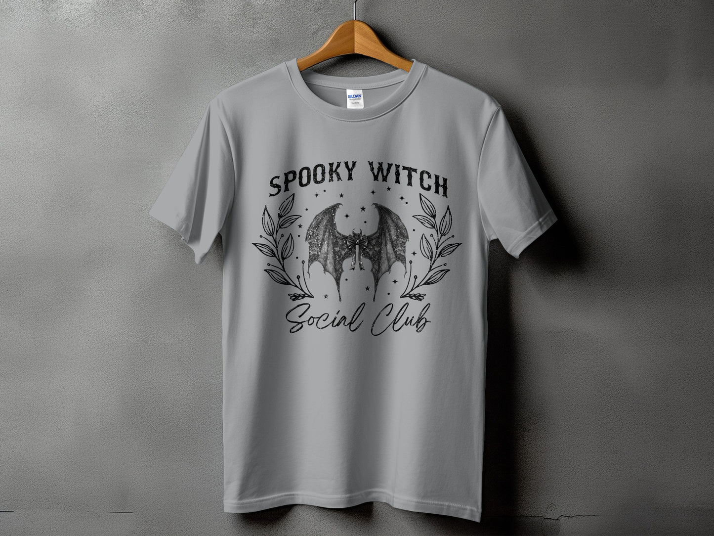 Grey t-shirt with "Spooky Witch Social Club" text and bat wings graphic.