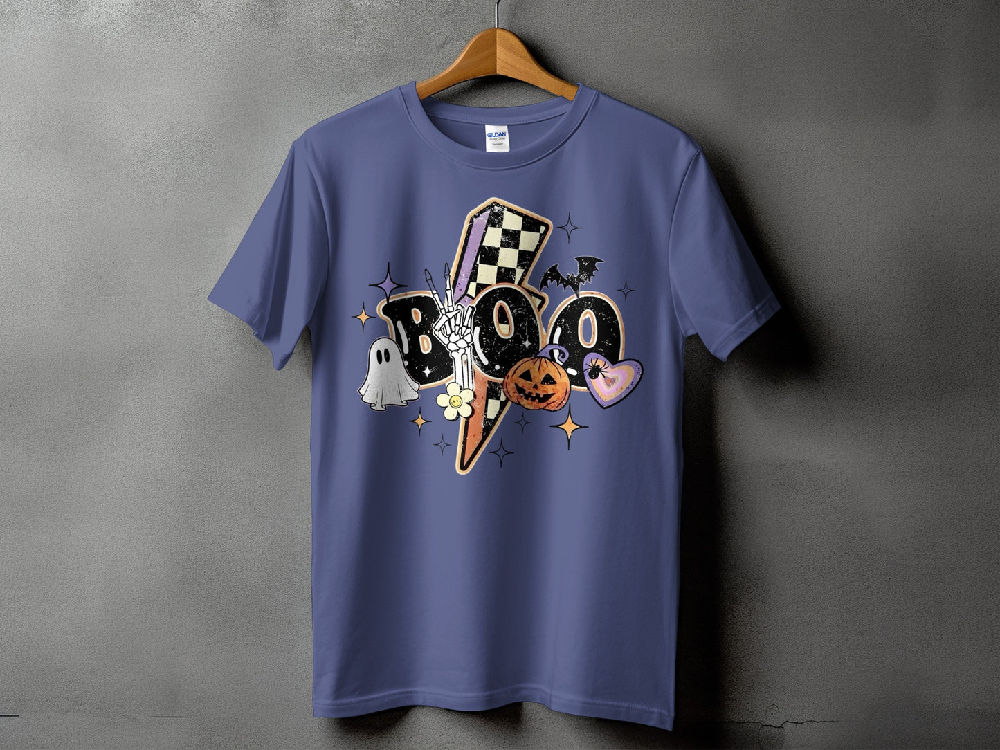 Purple t-shirt with Halloween "BOO" graphic featuring ghost, skeleton hand, pumpkin, and lightning bolt.