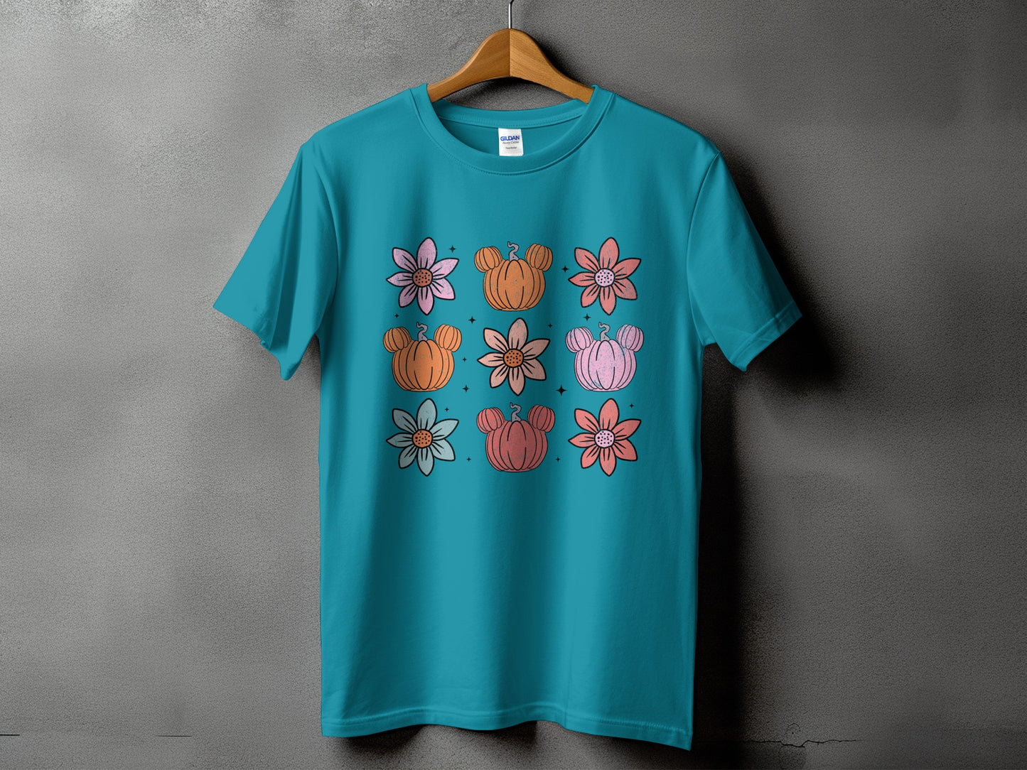 Teal t-shirt with a grid of flowers and Mickey Mouse pumpkins.