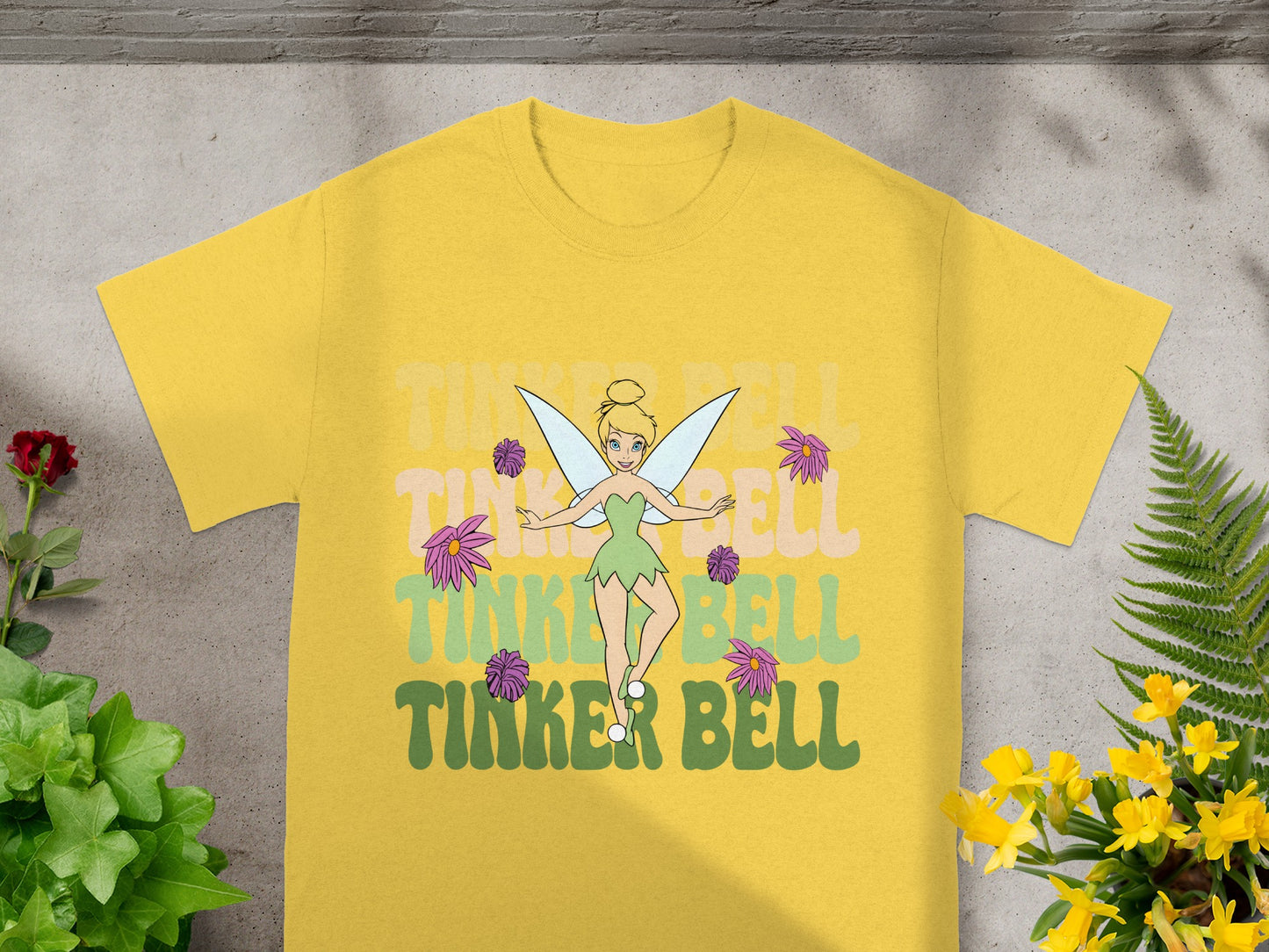 Yellow t-shirt with Tinker Bell illustration and "Tinker Bell" text.
