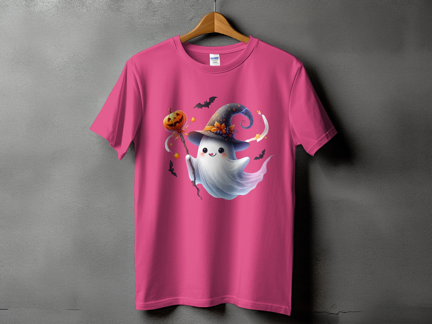 Pink t-shirt with a cute ghost in a witch hat holding a pumpkin wand.