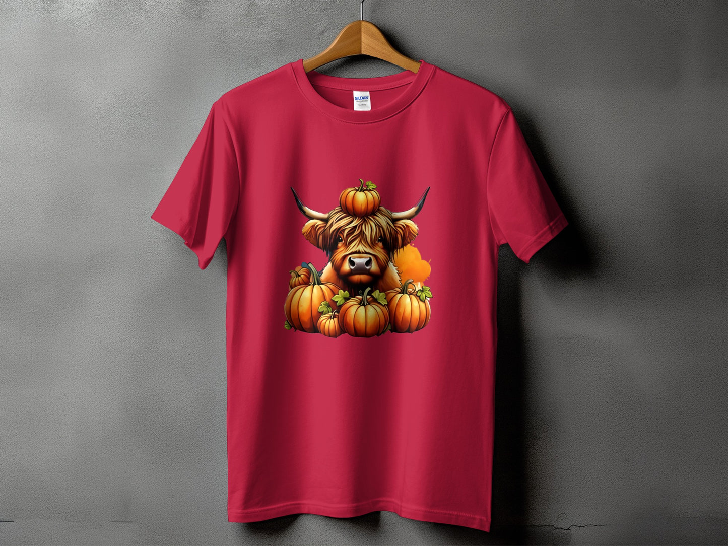 Highland cow with pumpkins on a red t-shirt.