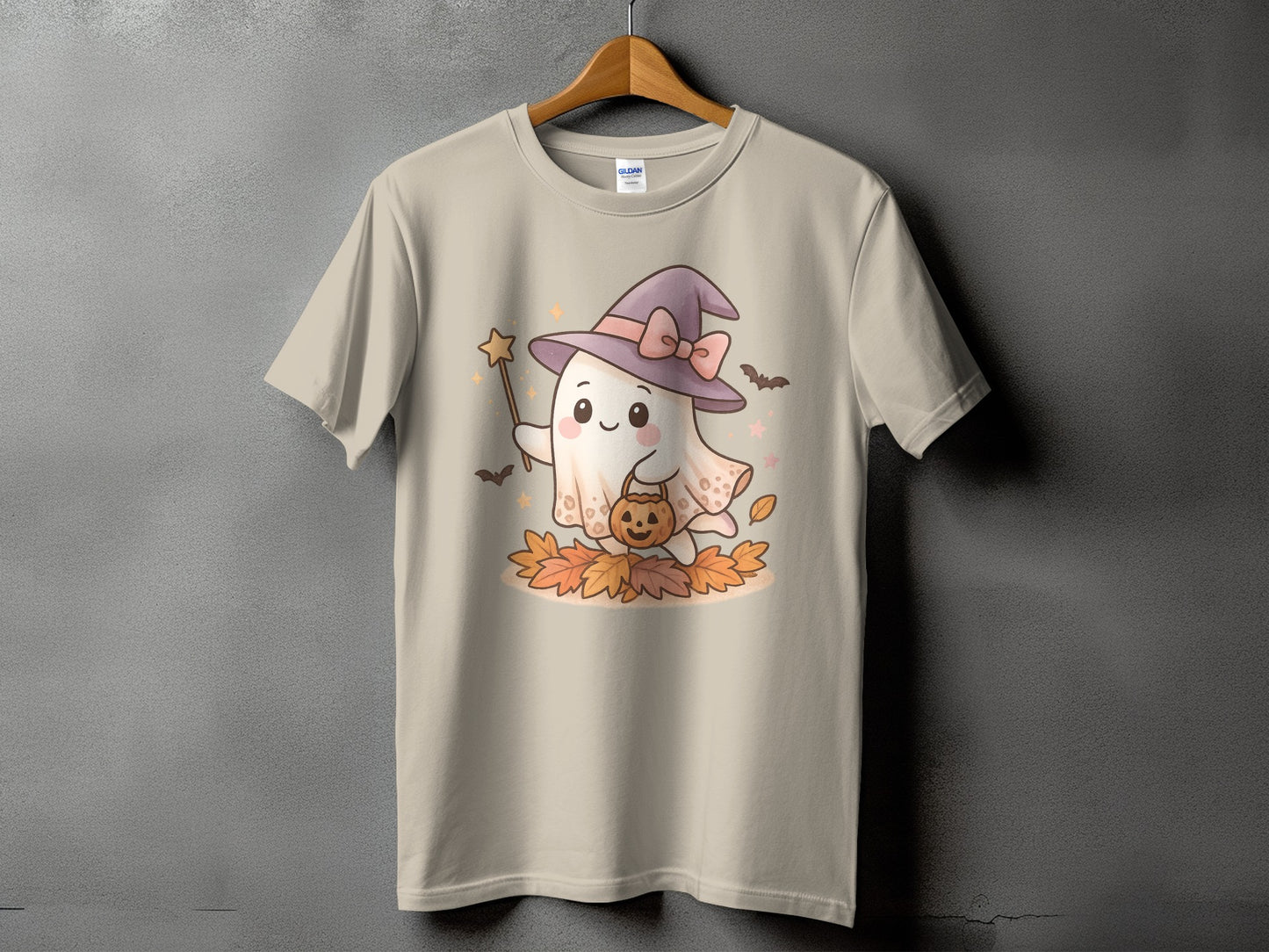 Ghost with witch hat holding pumpkin bucket and star wand on autumn leaves.