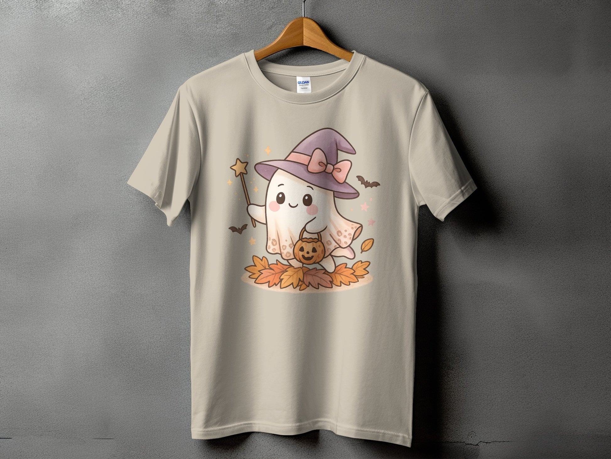 Ghost with witch hat holding pumpkin bucket and star wand on autumn leaves.