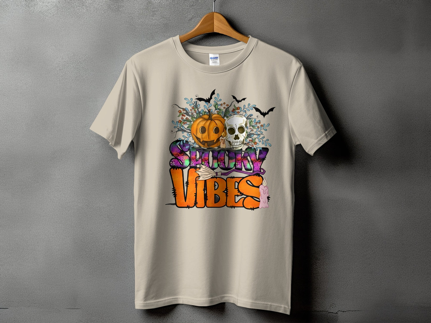 T-shirt with Halloween graphic featuring pumpkin, skull, bats, and "Spooky Vibes" text.