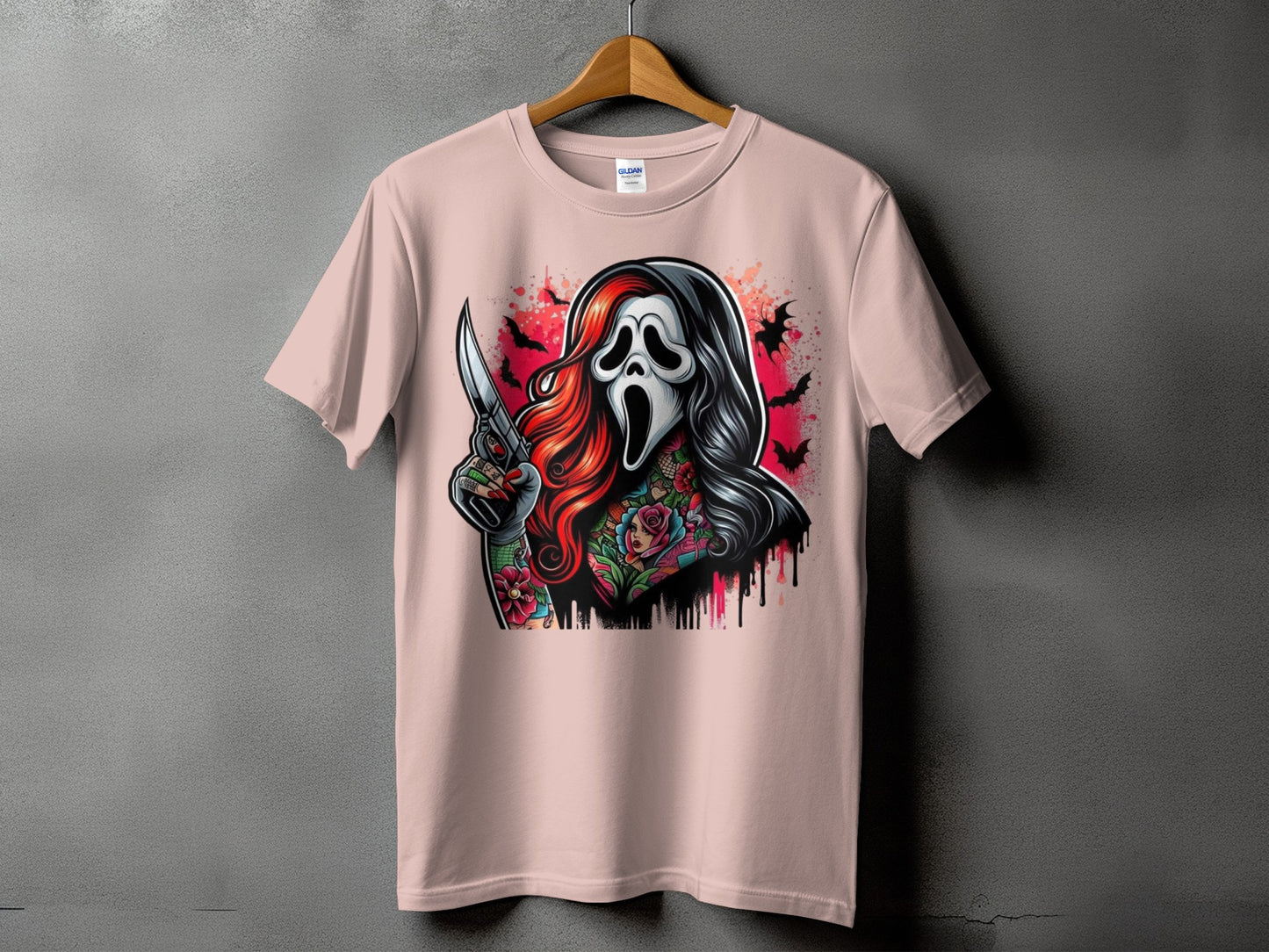 Ghostface mask figure with knife, tattoos, and bats on a pink t-shirt.