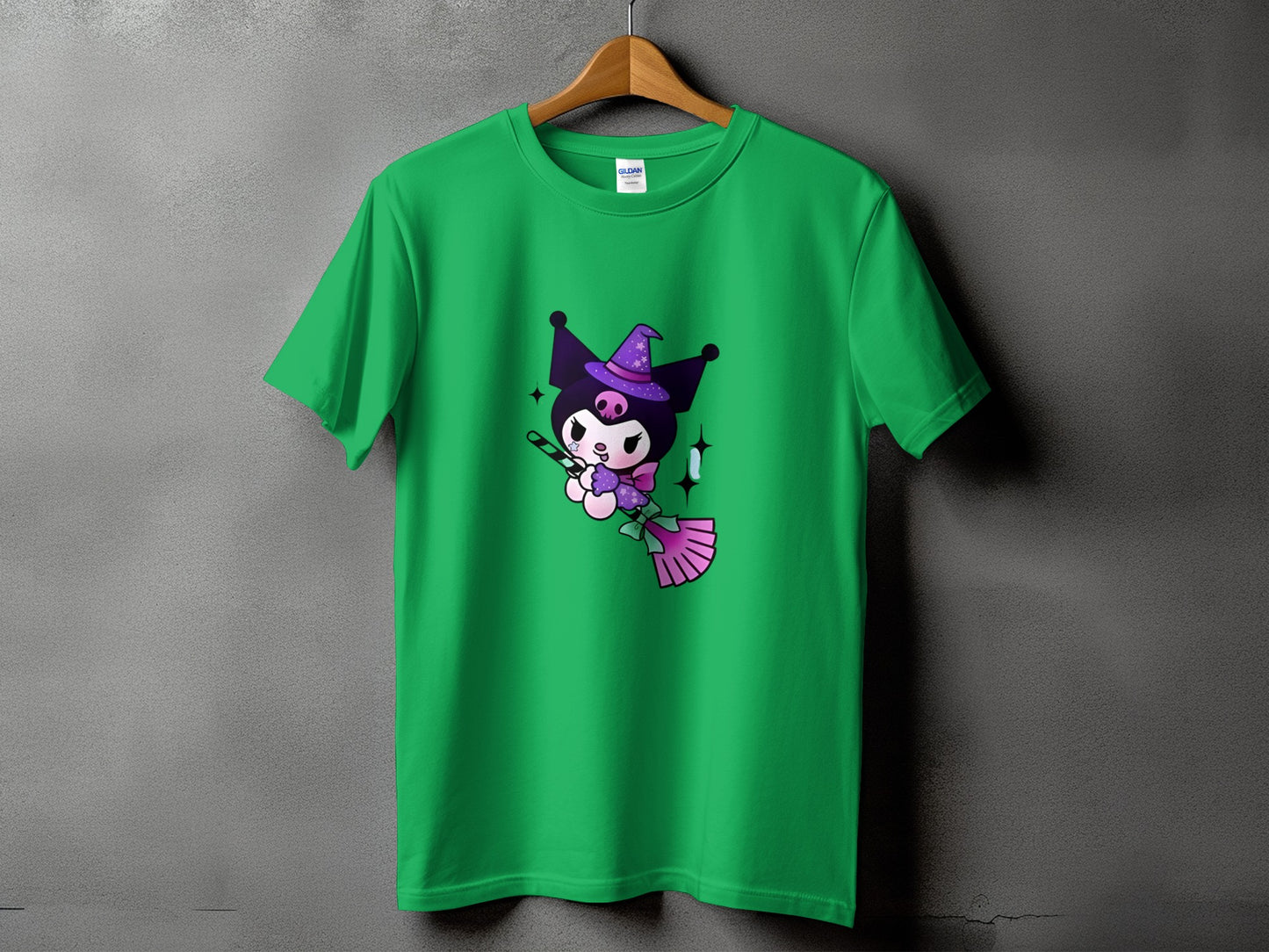Green t-shirt with Kuromi dressed as a witch flying on a broomstick.