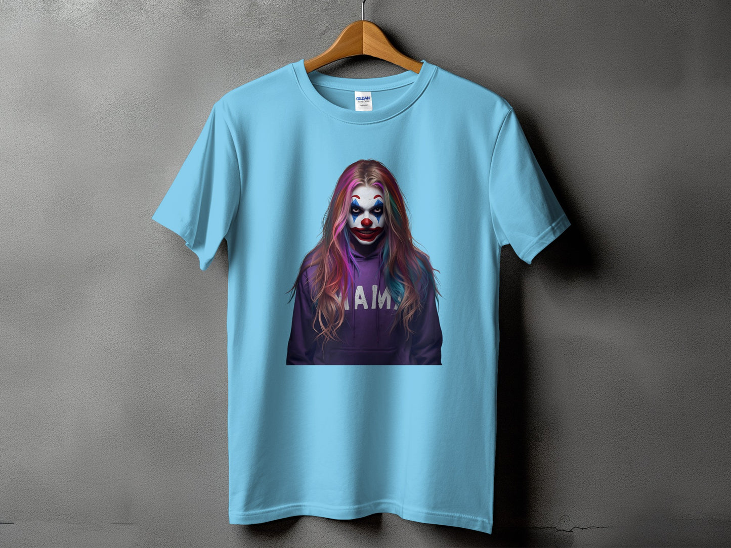 Light blue t-shirt with a graphic of a person in clown makeup and rainbow hair.