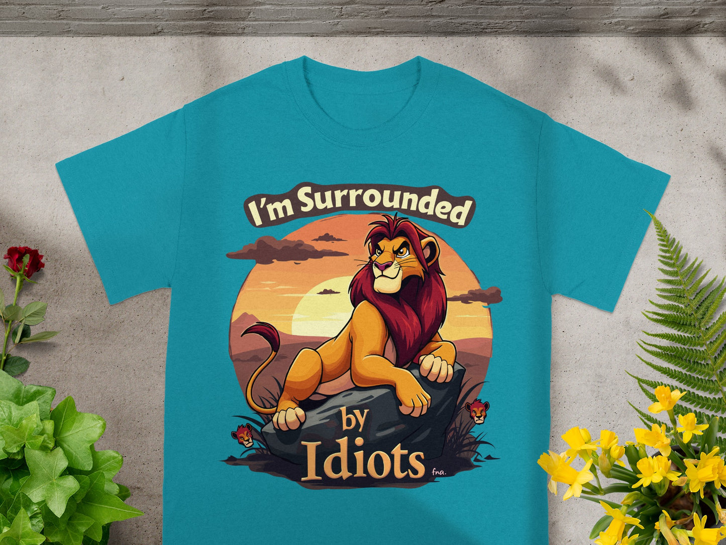 Teal t-shirt with lion graphic and text "I'm Surrounded by Idiots."