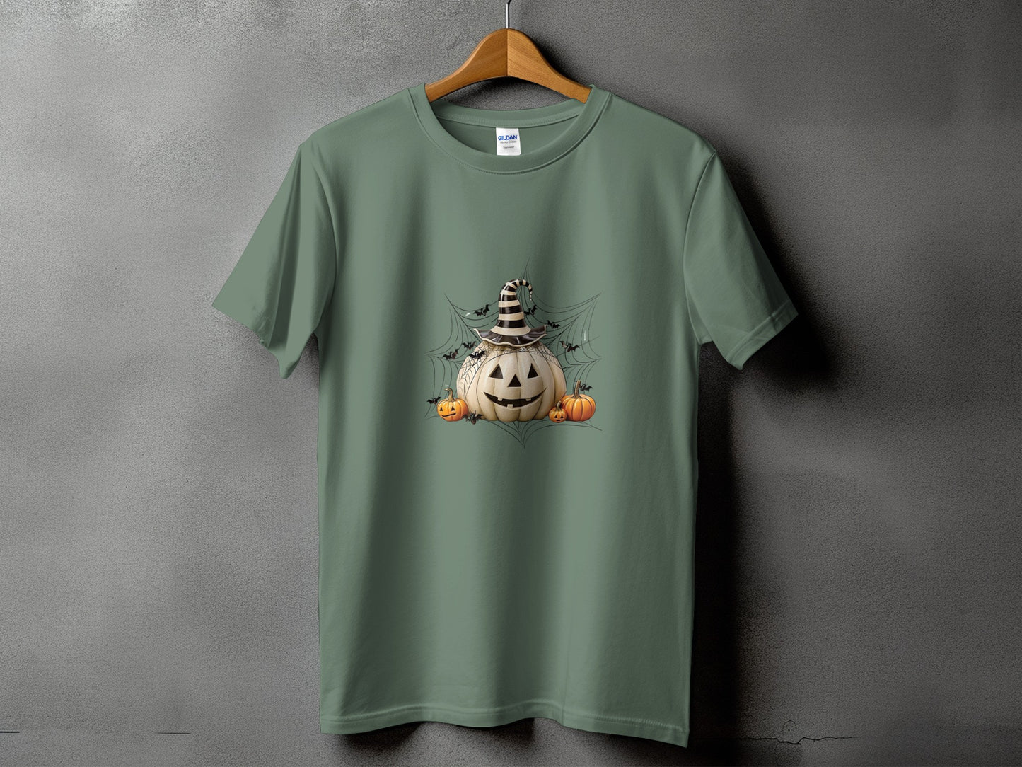 Green t-shirt with a jack-o'-lantern, smaller pumpkins, bats, and spiderweb design.