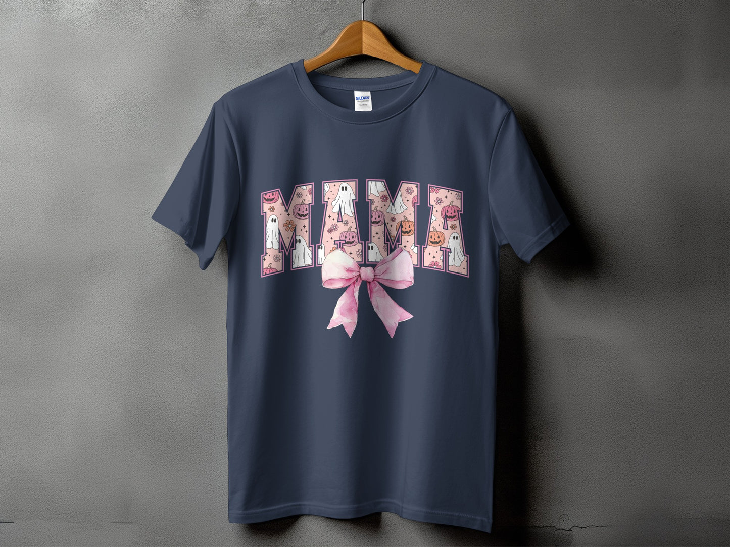 Navy t-shirt with "MAMA" text featuring Halloween ghosts and pumpkins, with a pink bow.