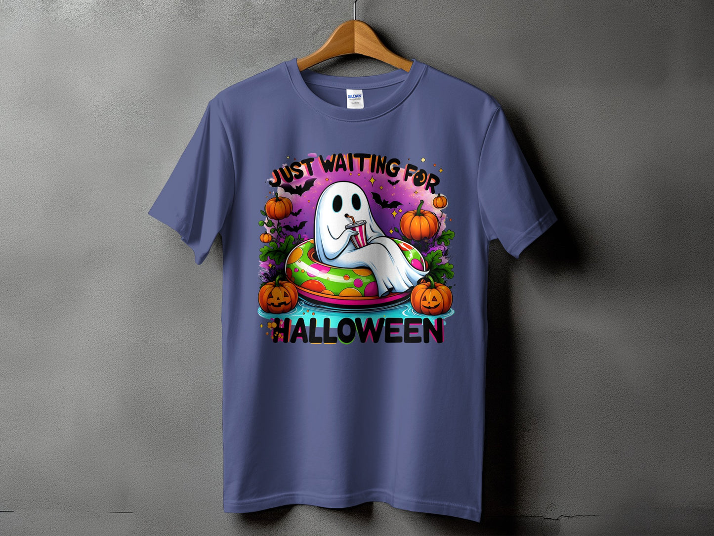 Ghost in inflatable ring with pumpkins and bats, "Just Waiting For Halloween".