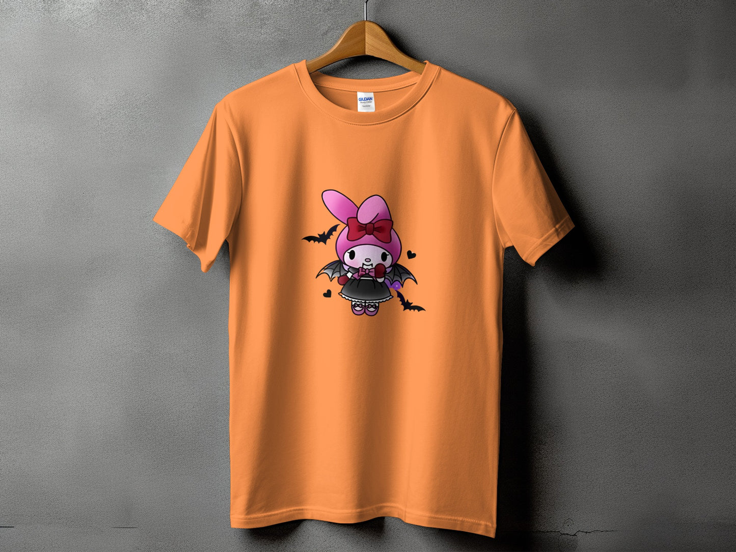 Orange t-shirt with cartoon bat girl character print.
