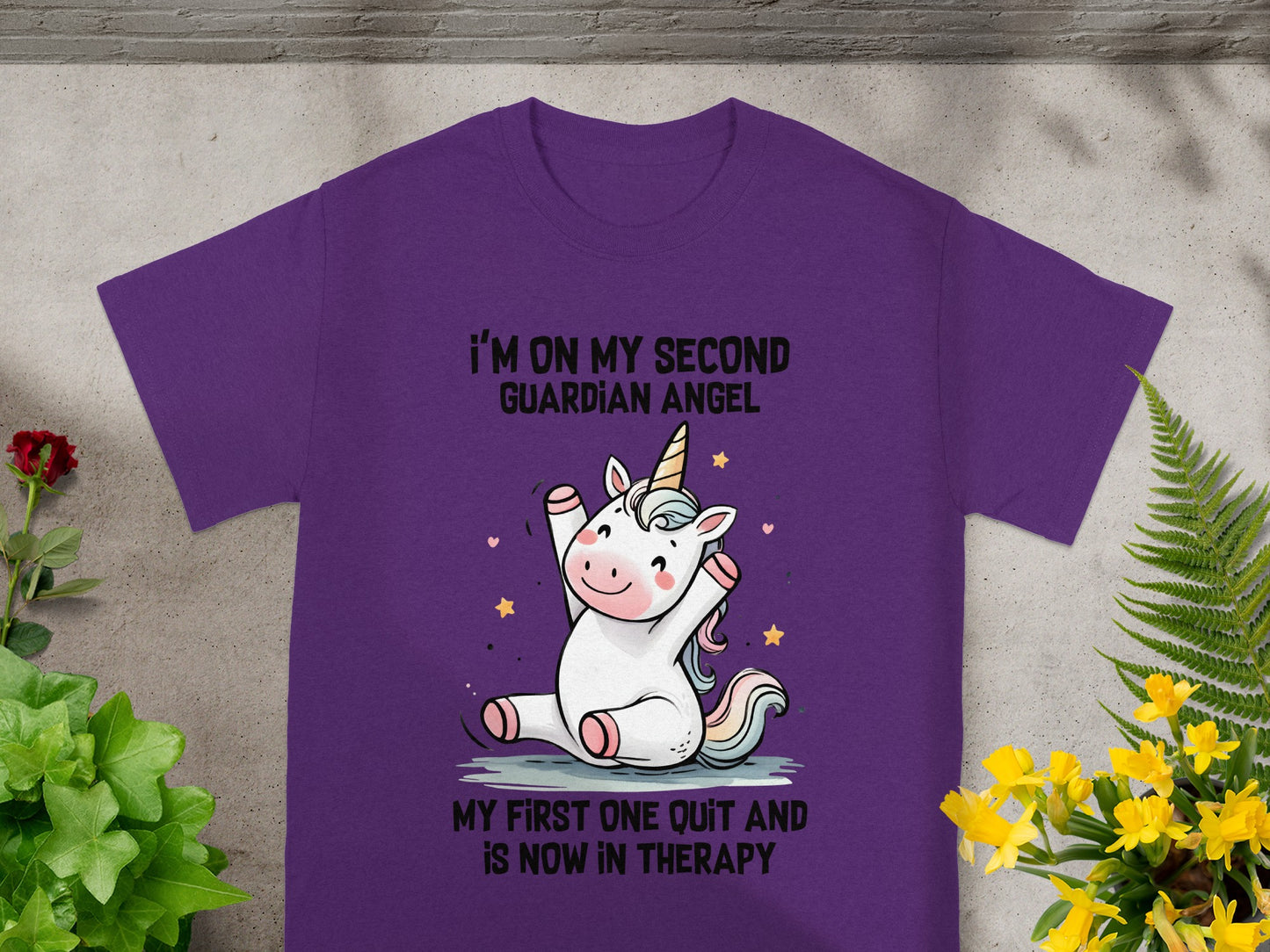 Purple t-shirt with unicorn graphic and text "I'm on my second guardian angel".