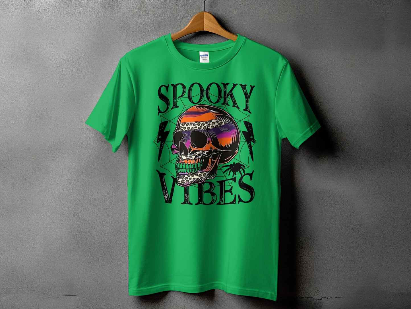 Green t-shirt with a skull graphic and the text "Spooky Vibes".